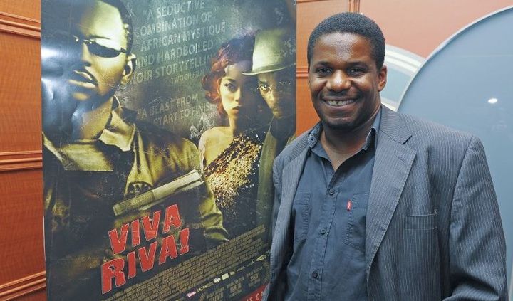 Le cinéaste Djo Tunda Wa Munga, devant l'affiche de son film, lors de sa projection à l'AFI Silver Theatre and Cultural Center le 7 juin 2011 à Silver Spring (Maryland, Etats-Unis).  (Leigh Vogel / GETTY IMAGES NORTH AMERICA / AFP)