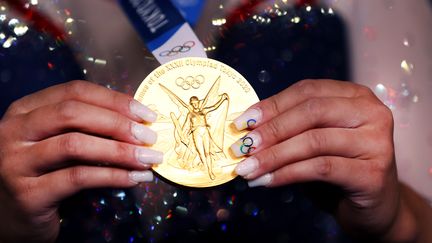 La gymnaste américaine Sunisa Lee présente sa médaille d'or après sa victoire au concours complet individuel aux Jeux de Tokyo, le 29 août 2021. (LAURENCE GRIFFITHS / GETTY IMAGES ASIAPAC)