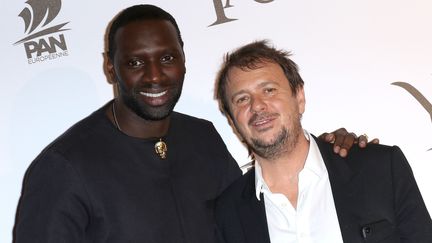 Le comédien Omar Sy et le cinéaste Philippe Godeau à la première parisienne du film "Yao", le 15 janvier 2019, au cinéma Le Grand Rex. (JEAN-MARC HAEDRICH/SIPA)