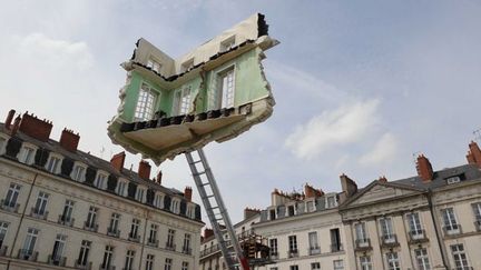 Workers put the final touch to Le monte meubles l ultime demenagement an art installation created by Argentianian Leandro Erlich. A journey to Nantes (Le voyage a Nantes), contemporary art event in Nantes wich runs to June 15 to August 19 2012. Nantes, FRANCE-14/06/2012./Credit:SALOM-GOMIS SEBASTIEN/SIPA/1206141850
 (SALOM-SEBASTIEN GOMIS/SIPA)