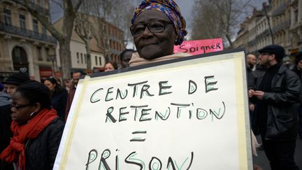 Une femme arbore une pancarte "Centre de rétention = prison" lors d'une manifestation contre la loi asile-immigration à Toulouse le 17 mars 2018.&nbsp; (ALAIN PITTON / NURPHOTO)