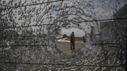 Un militaire ukrainien se tient à un point de contrôle dans le village de Velyka Dymerka, à l'est de Kiev (Ukraine), le 9 mars 2022.&nbsp; (ARIS MESSINIS / AFP)