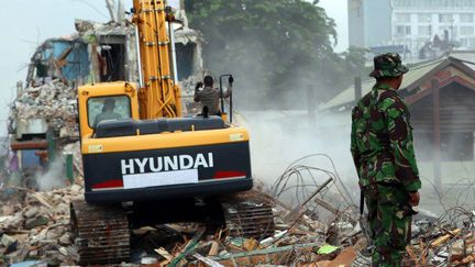 Un soldat indonésien surveille la destruction au bulldozer d'un quartier chaud de Jakarta, le 29 février 2016. (CITIZENSIDE / Natanael)