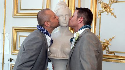 Patrice Strub (G) et Yves Lorentz (D) embrassent le buste de Marianne apr&egrave;s leur mariage, &agrave; Strasbourg (Bas-Rhin), le 15 juin 2013. (PATRICK HERTZOG / AFP)