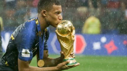 Le footballeur français Kylian Mbappé embrasse la Coupe du monde après la victoire de la France face à la Croatie en finale du Mondial, le 15 juillet 2018 à Moscou (Russie).&nbsp; (THIAGO BERNARDES / FRAMEPHOTO / AFP)