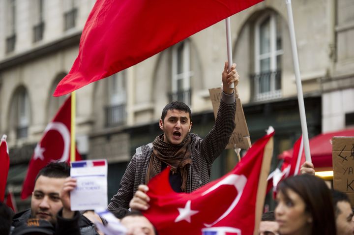 Des manifestants pro-Turquie d&eacute;filent devant l'Assembl&eacute;e nationale, &agrave; Paris, le 22 d&eacute;cembre 2011, pour protester contre la loi punissant la n&eacute;gation du g&eacute;nocide arm&eacute;nien. (FRED DUFOUR / AFP)