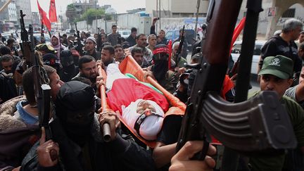 Des membres du Front d&eacute;mocratique pour la lib&eacute;ration de la Palestine portent le corps d'un homme tu&eacute; par un raid isra&eacute;lien, &agrave; Rafah, dans le sud de la bande de Gaza, le 31 octobre 2011.&nbsp; (SAID KHATIB /AFP&nbsp;)