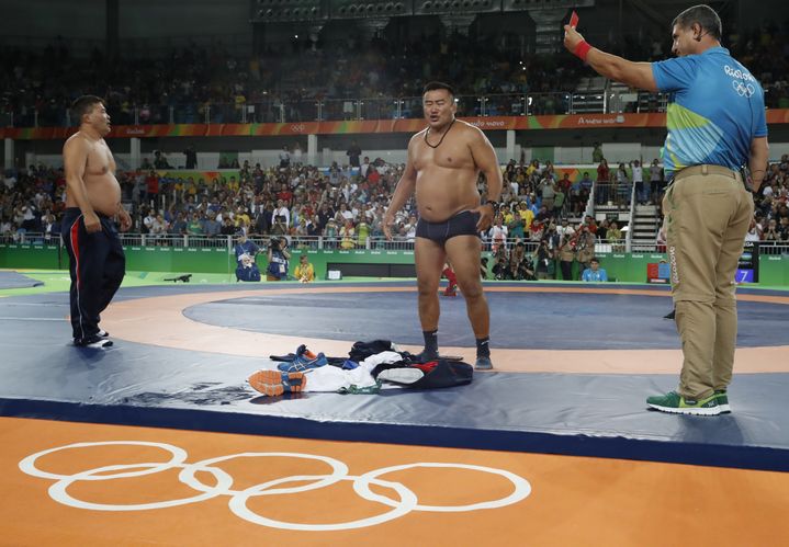 Furieux contre les juges, deux entraîneurs mongols se déshabillent sur le tapis de lutte, dimanche 21 août, aux Jeux de Rio. (JACK GUEZ / AFP)