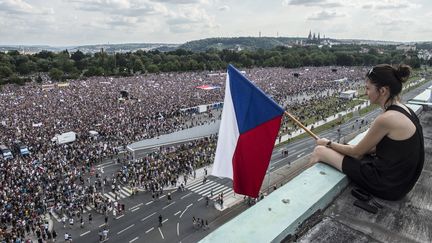 Une femme brandit un drapeau tchèque pendant une manifestation réclamant la démission du Premier ministre, le 23 juin 2019, à Prague. (MICHAL CIZEK / AFP)