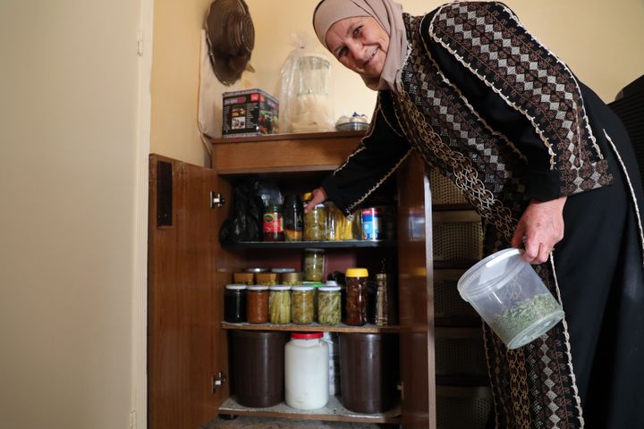 Haddla Shemaly shows the cupboard of canned food made for the winter, in her house in El Marj, October 30, 2021. (PIERRE-LOUIS CARON / FRANCEINFO)