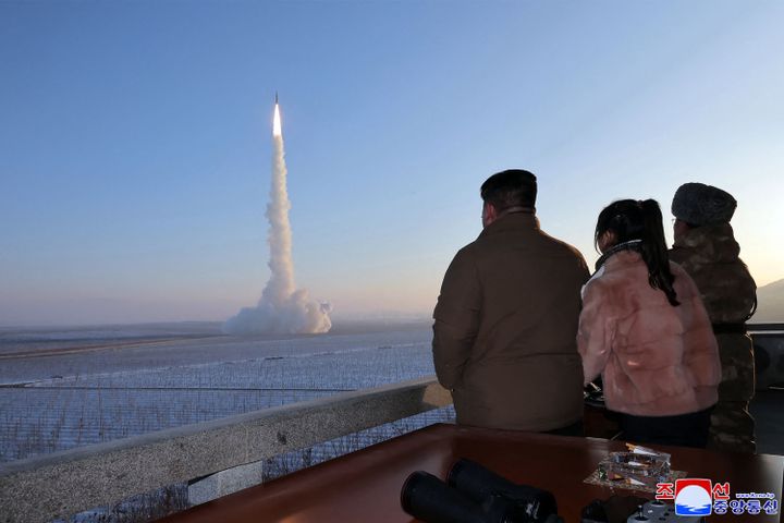 An undated photo released by KCNA agency on Dec. 19, 2023 shows Kim Jong-un (left) and his daughter (center) attending a missile launch in North Korea.  (KCNA VIA KNS/AFP)