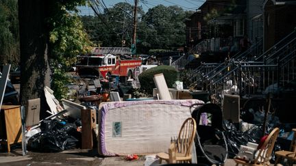 A New York (Etats-Unis), des habitants du Queens trient des objets et du mobilier endommagés par les intempéries&nbsp;dues au passage de la tempête Ida, le 2 septembre 2021. (SCOTT HEINS / GETTY IMAGES NORTH AMERICA via AFP)