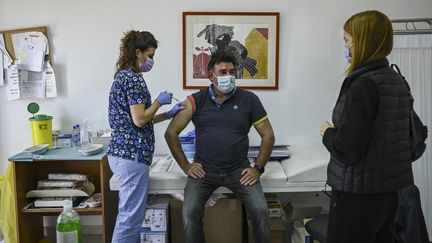 Un homme se fait vacciner, le 23 avril 2021&nbsp;sur l'île d'Elafonissos (Grèce). (ARIS MESSINIS / AFP)