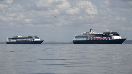 Les navires de croisière le Zaandam (à droite) et le Rotterdam (à gauche) entre dans la baie de Panama City, le 27 mars 2020. (LUIS ACOSTA / AFP)