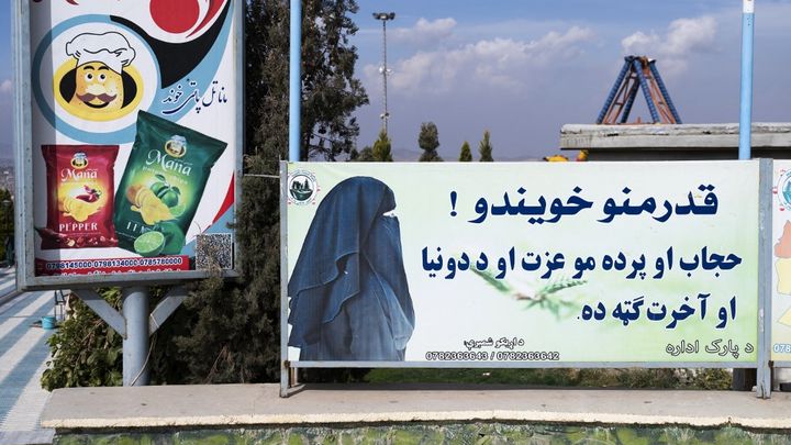 This poster, photographed on November 9, 2022 in Kabul, Afghanistan, reads: "Dear sisters, the hijab and the veil are your dignity and are useful to you in the world and in the hereafter." (WAKIL KOHSAR / AFP)