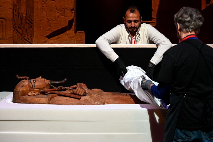 The installation of the sarcophagus of Ramses II in the great hall of La Villette, on April 3, 2023, in Paris.  (CHRISTOPHE ARCHAMBAULT / AFP)