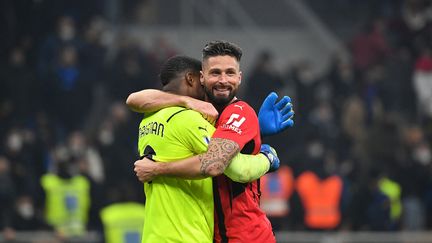 Les joueurs de l'AC Milan Olivier Giroud (à droite)&nbsp;et Mike Maignan après leur victoire contre l'Inter Milan, le 5 février 2022. (ISABELLA BONOTTO / AFP)