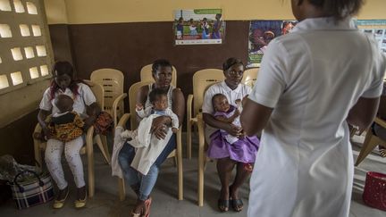 Une infirmière explique les moyens de protéger les enfants contre le paludisme et les performances du vaccin RTS,S à la polyclinique Ewin de Cape Coast au Ghana, le 30 avril 2019. (CRISTINA ALDEHUELA / AFP)
