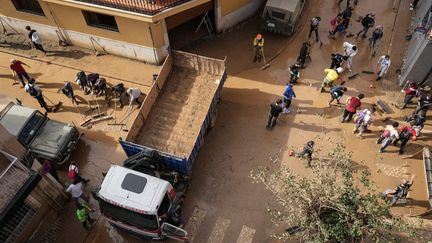 Les habitants d'Aldaia, près de Valence, en Espagne, nettoient les rues de leur ville, le 5 novembre 2024. (CESAR MANSO / AFP)