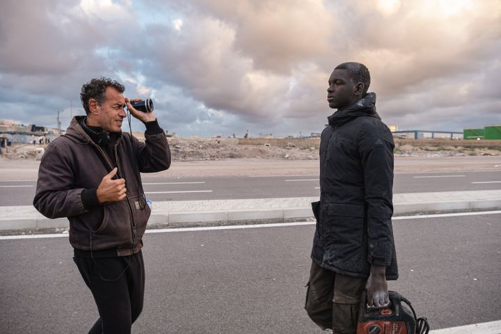 Director Matteo Garrone and actor Seydou Sarr during the filming of the film 