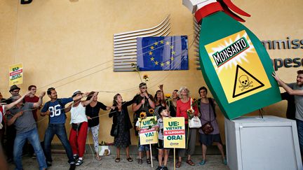 Des personnes manifestent contre le géant américain de l'agrochimie Monsanto, à l'extérieur de la Commission européenne à Bruxelles (Belgique), le 19 juillet 2017.&nbsp; (ALEXANDROS MICHAILIDIS / AFP)