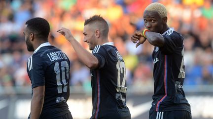 La joie des Lyonnais Lacazette, Ferri et Yattara (MICHAL CIZEK / AFP)