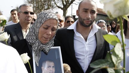 Latifa Ibn Ziaten, la m&egrave;re de l'un des soldats tu&eacute; par Mohamed Merah, montre une photo de son fils lors d'une marche, le 24 mars 2012. (CHARLY TRIBALLEAU / AFP)