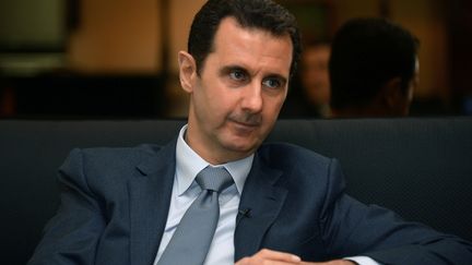 Le pr&eacute;sident syrien Bachar Al-Assad, lors d'une interview, &agrave; Damas (Syrie), le 4 d&eacute;cembre 2014. ( SANA / AFP)