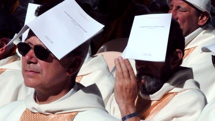 Des pr&ecirc;tres prient le jour de l'Assomption, &agrave; Lourdes. (PASCAL PAVANI / AFP)