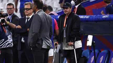 Romain Ntamack, en béquilles avant le match entre la France et la Namibie, le 21 septembre 2023 à Marseille. (ANNE-CHRISTINE POUJOULAT / AFP)