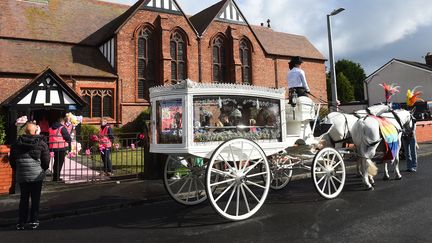 A horse-drawn carriage carries the coffin of Southport stabbing victim Elsie Dot Stancombe as she waits outside St John's Church, Birkdale, near Southport, northwest England, on August 23, 2024, during the funeral. (PETER POWELL / AFP)