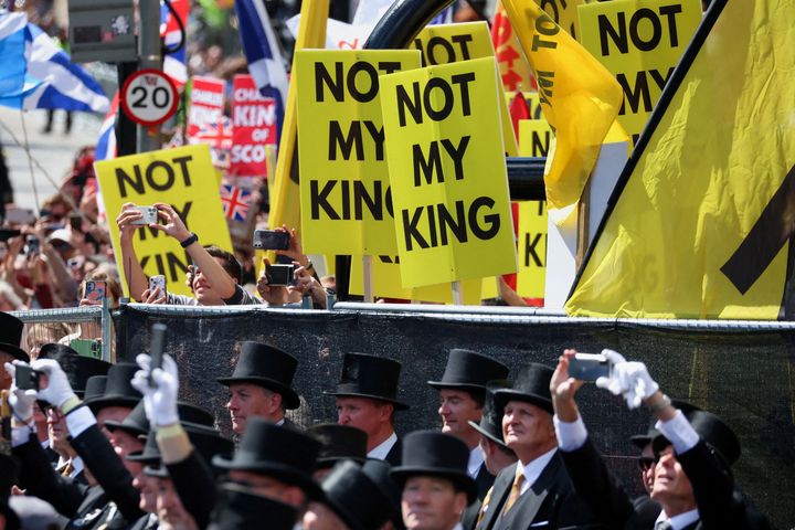 Protesters hold up signs 