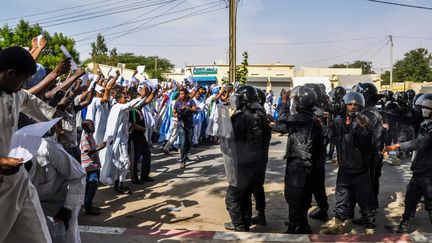 Des manifestants font face à la police anti-émeute, à Nouakchott, le 10 novembre 2017, pour protester contre la décision de la cour d'appel de Nouadhibou de commuer la peine de mort pour apostasie prononcée contre Ould Mkheitir en deux ans de prison. (STR / AFP)