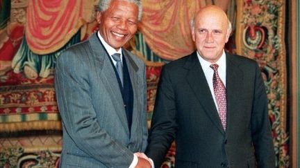 Poignée de mains légendaire entre Nelson Mandela et Frederik De Klerk à Oslo, le 10 décembre 1993. Tous deux ont reçu le prix Nobel de la Paix. (GERARD JULIEN / AFP)