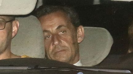 &nbsp; (Nicolas Sarkozy à la sortie du bureau des juges d'instruction @ Reuters-Pascal Rossignol)