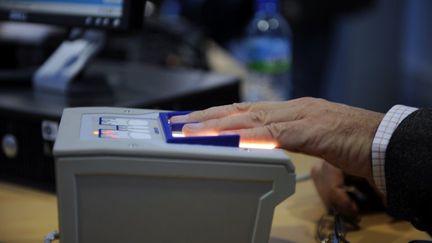 Un passager se fait relever ses empreintes digitales, le 19 octobre 2009 &agrave; l'a&eacute;roport Roissy-Charles-de-Gaulle. (FRED DUFOUR / AFP)