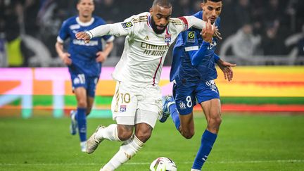 Alexandre Lacazette in contact with Azzedine Ounahi during the Ligue 1 match between Lyon and Marseille, February 4, 2024. (AFP)