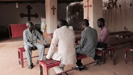 Le pasteur luthérien&nbsp;Yousef Zamgila en train de parler avec des membres de sa congrégation religieuse dans une petite église improvisée à Ondurman, près de Khartoum (capitale du Soudan) le 22 août 2019. (JEAN MARC MOJON / AFP)