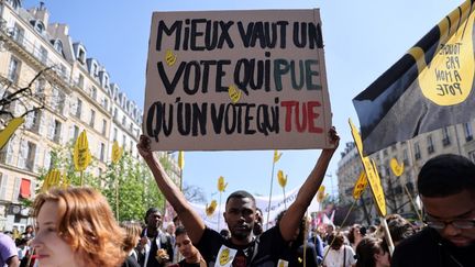 Un&nbsp;participant à la manifestation contre l'extrême droite, à Paris, le 16 avril 2022. (THOMAS COEX / AFP)