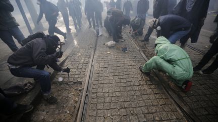 En diff&eacute;rents endroits du parcours de la manifestation, des participants ont tir&eacute; des projectiles (bouteilles, canettes, billes d'acier, fus&eacute;es de d&eacute;tresse) en direction des forces de l'ordre qui ont charg&eacute; &agrave; plusieurs reprises. Des pav&eacute;s entourant les rames du tramway ont aussi &eacute;t&eacute;&nbsp;descell&eacute;s.&nbsp; (STEPHANE MAHE / REUTERS)