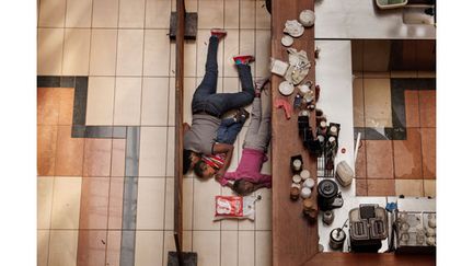 Sept. 21, 2013. A woman tried to shelter children from gunfire by Somali militants at the Westgate mall in Nairobi, Kenya, in an attack that killed more than 70 people. Tyler Hicks made this photo from a floor above, in an exposed area where the police feared for his safety.
 (Tyler Hicks 2013 - The New York Times)