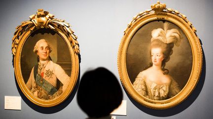 Une visiteuse devant les portrait de Louis XVI et de Marie-antoinette à l'exposition "Marie-Antoinette, une reine à Versailles" au Mori Arts Center  Gallery, à Tokyo (2016-2017)
 (BEHROUZ MEHRI / AFP)