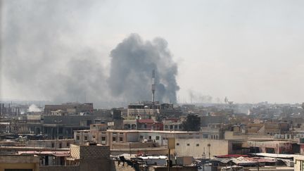 De la fumée s'échappe depuis un secteur de Mossoul (Irak), samedi 25 mars 2017, après une frappe aérienne menée en appui de troupes engagées contre le groupe Etat islamique. (AHMAD AL-RUBAYE / AFP)