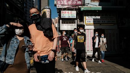 Des piétons portant des masques, à Hong Kong, le 16 avril 2020. (ANTHONY WALLACE / AFP)