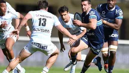 Le Racingman Henry Chavancy en défense face au Montpellierain Henry Immelman, soutenu par Fulgence Ouedraogo sous le regard de Dan Carter (PASCAL GUYOT / AFP)