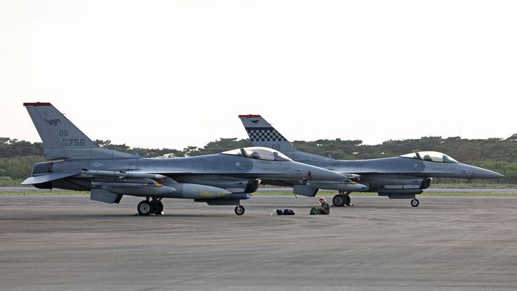 Two US Air Force F-16s at Shimoji Island Airport in Miyako, Okinawa Prefecture, Japan on April 8, 2023.  (TOSEI KISANUKI/YOMIURI/AFP)