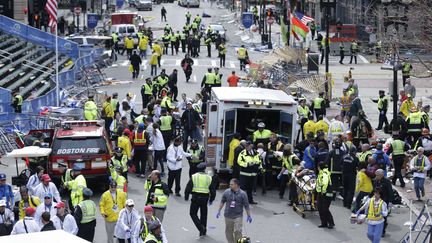 Des services d'urgence viennent en aide aux bless&eacute;s sur la ligne d'arriv&eacute;e du marathon de Boston (Massachusetts), 15 avril 2013. (CHARLES KRUPA / AP / SIPA)