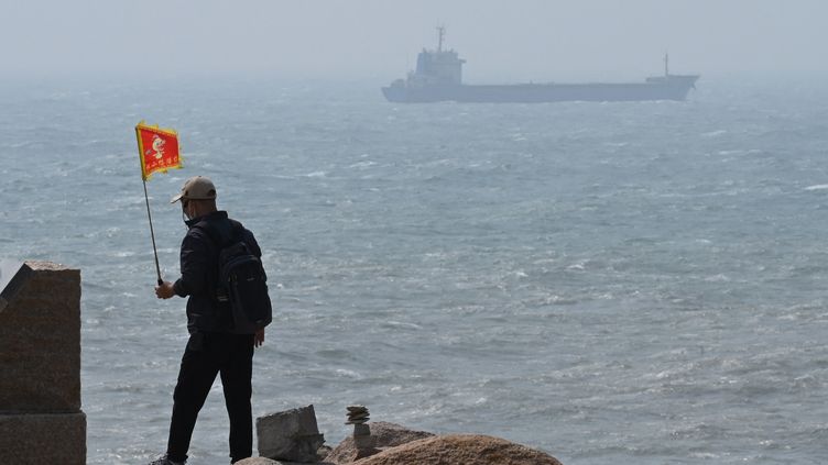 A man walks on the Chinese island of Pingtan, the closest point to Taiwan, on April 8, 2023, as Beijing kicked off three days of military exercises around the island.  (GREG BAKER / AFP)