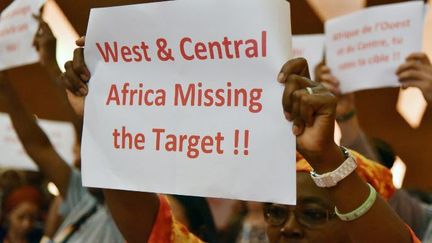 Des manifestants brandissent des pancartes, le 4 décembre 2017, lors de l'ouverture de la 19e conférence sur le sida à Abijan (Côte d'Ivoire). (SIA-KAMBOU / AFP)