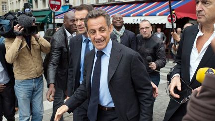 Nicolas Sarkozy sort d'un caf&eacute; apr&egrave;s avoir vu le film "Le Serment de Tobrouk" de Bernard-Henri L&eacute;vy (&agrave; dr.), le 5 juin 2012, &agrave; Paris.&nbsp; (MARTIN BUREAU / AFP)